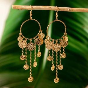 Detail view of golden bohemian hoop earrings with cascading metallic fringe and small round discs