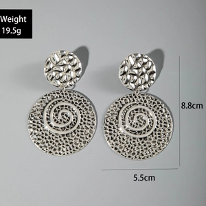 Detailed view of silver ethnic earrings with hammered texture measuring 8.8cm in height