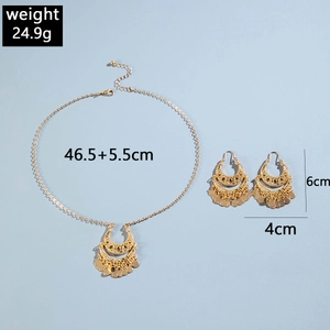 Detail view of retro gold tassel necklace and moon earrings set with size measurements