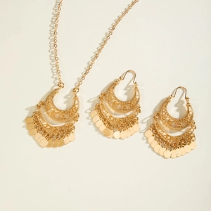 Detailed view of bohemian gold filigree crescent necklace and tassel earring jewelry set