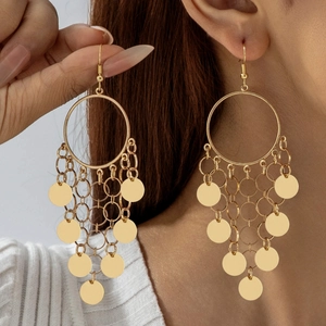 Detail shot of gold multi-layer disc tassel earrings on a model in bohemian style