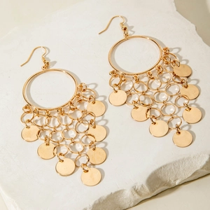 Detail of gold bohemian hoop earrings with layered interlocking rings and metal sequins