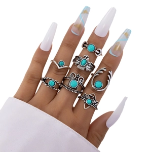 7-piece bohemian ring set with turquoise stones and vintage eagle designs on model's hand