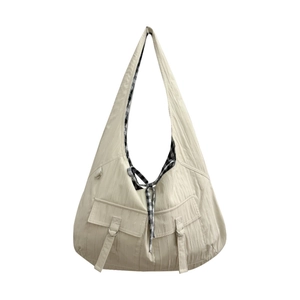 Minimalist beige canvas shoulder bag with pleated texture and plaid lining main view