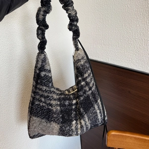 Detail of winter checkered plush tote bag featuring a soft scrunchie handle design