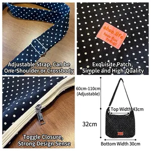 Black and white polka dot canvas tote bag with adjustable strap and zip closure