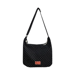 Polka dot canvas shoulder bag in black and white with adjustable strap and pink label