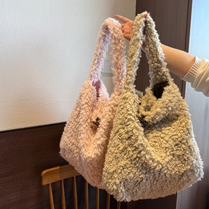 Close-up of plush fleece tote bags in pink and beige featuring toggle button closures