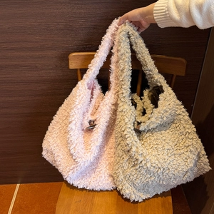 Detail of plush faux fur tote bags with toggle button closure on a wooden chair
