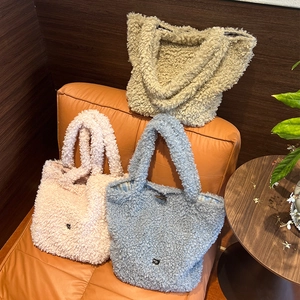Plush teddy fleece tote bags in pink, blue, and beige with wooden horn buckle details