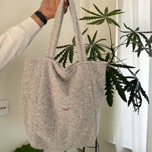 Fuzzy gray plush tote bag featuring a soft faux mohair texture and heart metal detail