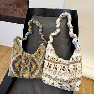 Close-up of bohemian plush bags with handmade metal logo and textured shoulder straps