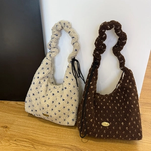 Detailed view of plush lamb wool hobo bags with polka dots and pleated handles
