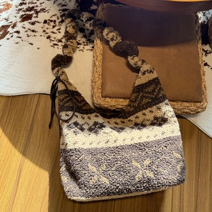 Detail of winter fleece tote bag with brown geometric jacquard pattern and plush strap