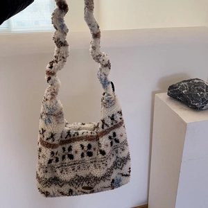 Detail of faux shearling handbag with ethnic jacquard pattern and wavy shoulder strap