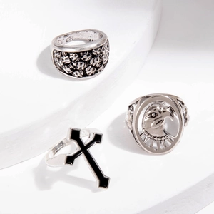 Detail of vintage punk silver rings set with eagle head and cross engravings