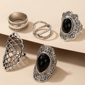 Detail of 5-piece vintage silver-plated rings with black gemstones on display