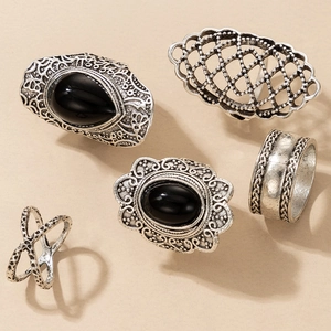Detail view of 5-piece bohemian silver ring set featuring black gems and vintage carvings