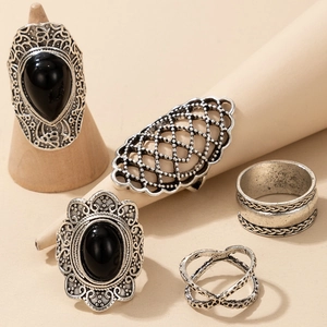 Detail of five-piece vintage silver rings set with teardrop gemstones and boho engravings