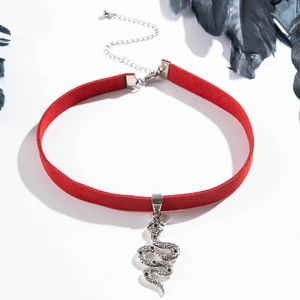 Detail van rode fluwelen choker met zilveren slangenhanger en karabijnsluiting op witte achtergrond