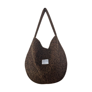 Minimalist large plush tote bag in dark brown fleece with stylish white text label