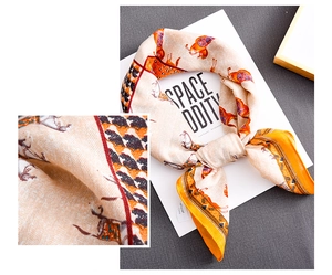 Detailed close-up showing the twill texture of a luxury silk-like scarf with horse pattern