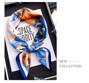 Close-up of luxury abstract print silk scarf folded in an elegant gift box set