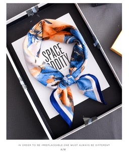 Detailed shot of an elegant abstract oil painting silk scarf in a premium gift box