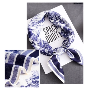 Detailed close-up of blue and white Toile de Jouy silk scarf with twill texture and stripes