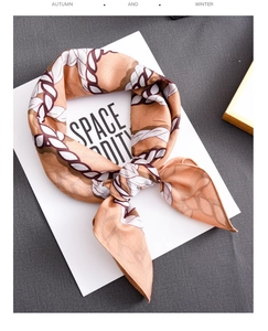 Detailed view of luxury silk scarf with contrast chain pattern in elegant orange and brown