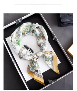 Close-up of elegant floral silk scarf with hand-rolled edges in a premium gift box