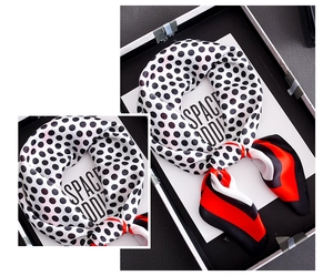 Detail of retro polka dot silk scarf featuring contrasting red and black corner blocks