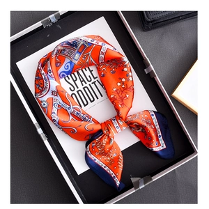 Detailed macro shot of vintage orange polka dot silk square scarf with blue borders