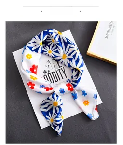 Detail view of colorful daisy print on high-quality faux silk scarf with floral patterns