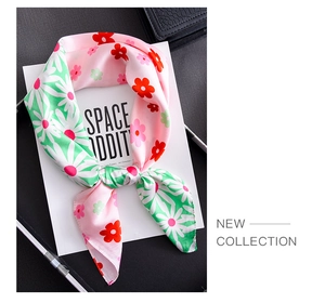 Detail of pink and green daisy pattern silk scarf with premium stitched edge finish