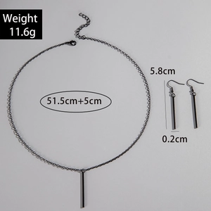 Flat lay of black geometric bar necklace and drop earrings set with size measurements