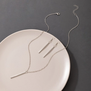 Detailed view of minimalist silver geometric bar earrings and matching Y-necklace set