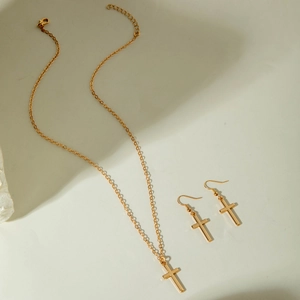 Detailed view of the gold-plated cross pendant necklace and matching hook earrings set