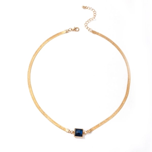 Golden snake chain necklace featuring a square blue gemstone pendant on white background