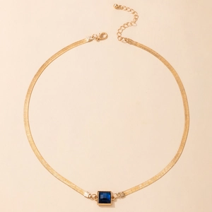 Detailed view of square blue gemstone pendant on a gold snake chain with lobster clasp