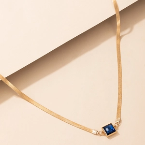 Elegant gold snake chain necklace featuring a square blue gemstone pendant centerpiece