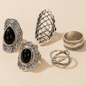 Detail of 5-piece vintage silver ring set with black turquoise and bohemian hollow patterns