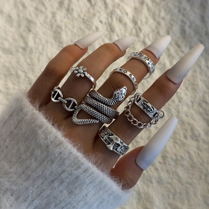 Detail of 7pcs vintage silver snake and gothic ring set worn on hand with cozy vibes