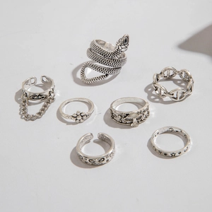 Macro detail of a 7-piece vintage silver snake and gothic butterfly alloy ring set