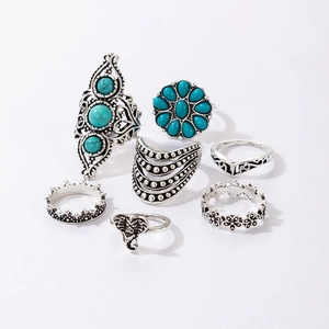 Detail of 7-piece vintage silver ring set featuring turquoise stones and elephant motifs