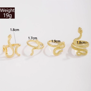 Detail view of four vintage gold snake rings with scale textures and size measurements