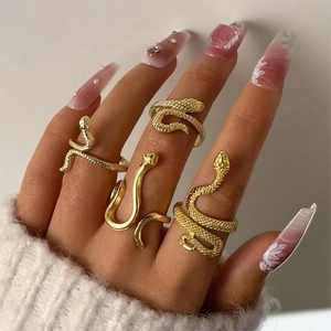 Set of four bohemian gold snake rings with scale texture and adjustable open bands