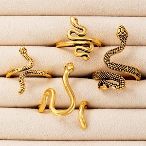 Macro detail of vintage gold snake ring set with scales and smooth gothic metal finish