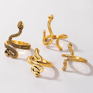 Four-piece vintage gold snake ring set featuring textured scales and minimalist spiral designs