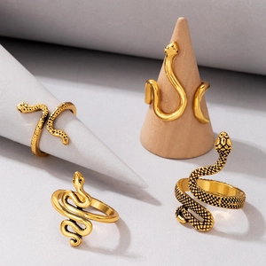 Detailed view of four vintage gold snake rings featuring embossed scale textures and curves